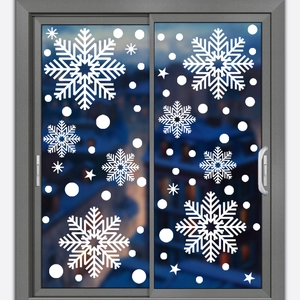 Detailed view of white snowflake static window decals on a glass surface for winter decor
