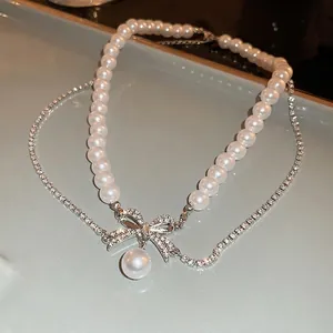 Collier double couche de perles exquis avec pendentif nœud en strass brillant pour femme