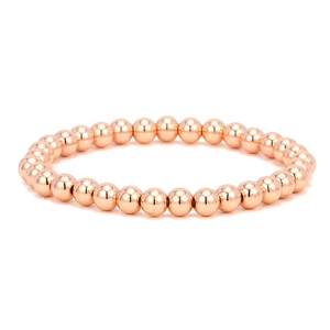 Macro detail of elastic stretch bracelet with polished 18K rose gold plated round beads