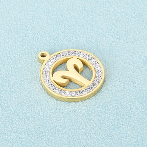 Golden Aries zodiac pendant with crystal stones on a blue textured background