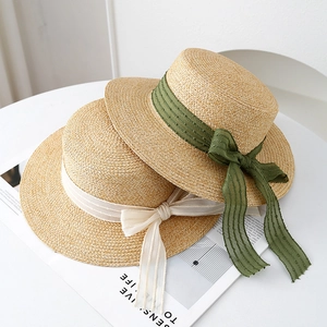 Flat top boater straw hat with elegant ribbon bows for summer beach sun protection