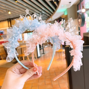Detail of pink and blue lace mesh hairbands for girls with sequined crowns and pearls
