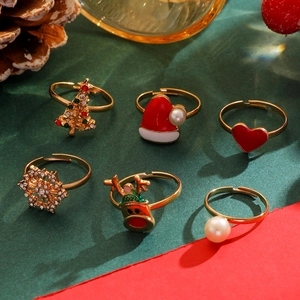 Detail of 6-piece adjustable Christmas ring set featuring reindeer and snowflake charms