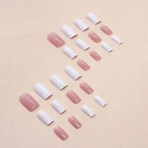 Pink and white glitter press-on nails with sweet floral and polka dot patterns