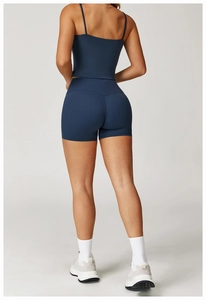 Detail view of the crisscross back straps on a navy blue brushed athletic yoga sports bra