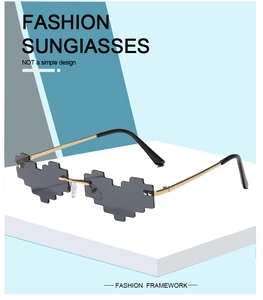 Detail of pixel heart-shaped rimless sunglasses with gold metal temples and gray lenses