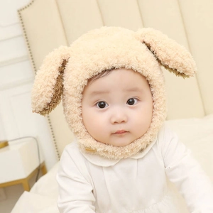 Plush beige baby hat with rabbit ears and warm ear protection for autumn and winter