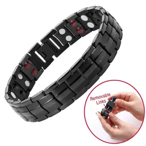Detail of black magnetic therapy bracelet with dragon pattern and length adjustment tool
