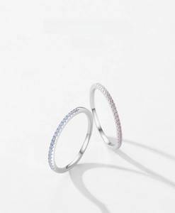 Close-up of minimalist S925 silver rings with blue and pink crystal stone pavé