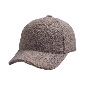 Close-up of solid color faux lamb wool baseball cap with warm bouclé texture.