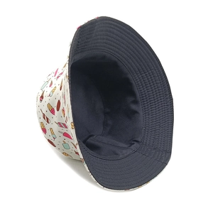Reversible bucket hat with ice cream print and black interior for sun protection