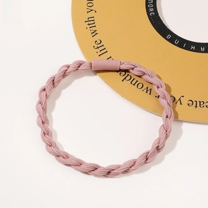Detail of lotus pink braided elastic hair tie with matte cylindrical connector