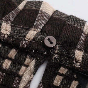 Close-up of brown honeycomb plaid shirt showing button details and fabric texture
