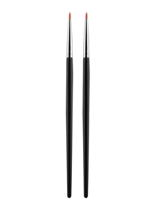 Detail view of two fine eyeliner brushes with black handles and orange synthetic bristles