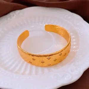 18k gold plated cuff bracelet with brushed metal finish and zircon star engravings