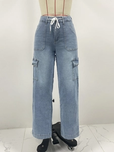 Detail of light blue denim cargo pants showing elastic drawstring waist and side pockets