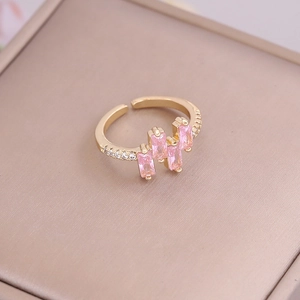 Macro detail of 18K gold ring with pink zircon stones and sparkling micro-inlay accents