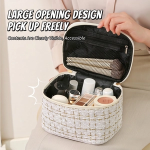 White tweed makeup bag with gold zipper and spacious interior shown in a home setting