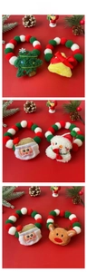 Detailed view of Christmas pet collars with colorful plush balls and festive ornaments