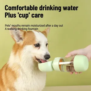 Portable pet water bottle with light green trough, shown feeding a Corgi dog outdoors