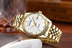 Close-up of golden diamond-set quartz watch with date window and fluted bezel detail