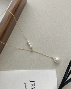 Close-up of S925 silver gold tassel necklace with elegant white pearl pendant details