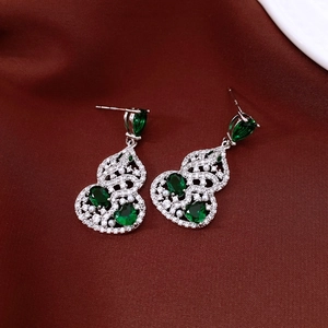 Chinese style silver earrings with green zircon hollow gourd pendant on red fabric