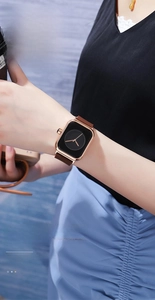 Close-up of a women's square quartz watch with rose gold case and brown leather strap