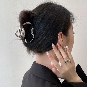 Minimalist silver metal shark hair claw clip in a sleek streamlined hollow design