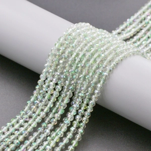 Macro detail of 4mm faceted green crystal glass beads with iridescent AB coating for DIY