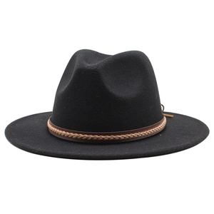 Detail of black wool jazz hat featuring a brown braided leather band on white background