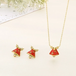 Detail of Christmas reindeer red bell jewelry set with gold finish and tiny zircons