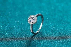 Macro shot of silver Moissanite ring with halo setting and pavé diamonds on the band