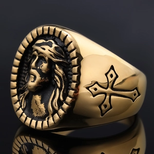 Gold stainless steel religious ring with Jesus relief and cross on black reflection