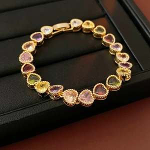 Detail of 18K gold plated heart bracelet with colorful cubic zirconia in a jewelry box