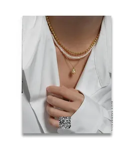 Three-layer layered necklace featuring golden beads, freshwater pearls and shell pendant