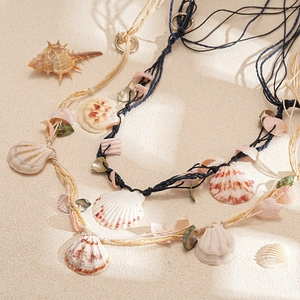 Handmade raffia woven shell necklace in navy blue and beige colors for summer beach vacations