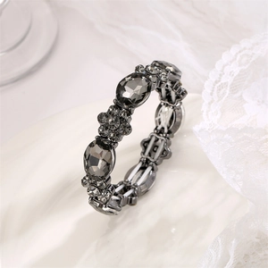 Detail of vintage stretch bracelet with grey faceted stones and crystal floral accents