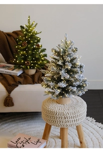 Mini Christmas trees with LED lights and wood bases in a cozy home interior setting