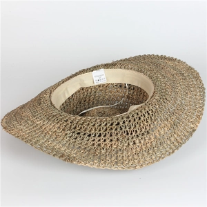 Detail of the 100% natural grass straw hat interior featuring a size 57 sweatband label