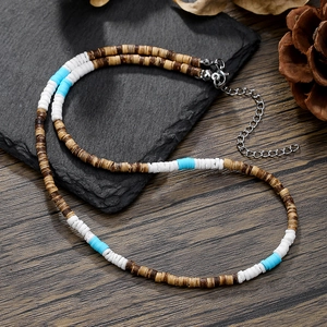 Bohemian necklace with brown white and turquoise beads on stone and wood surface