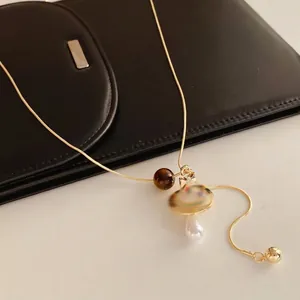 Tiger eye cross droplet pendant on gold snake chain necklace with luxury pearls
