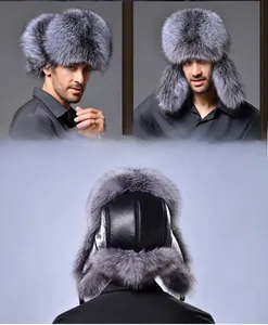 Detail of grey fox fur trapper hat featuring black leather crown and thick ear flaps