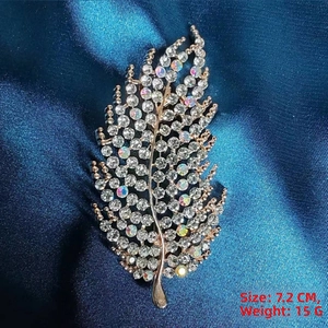 Detailed close-up of a crystal leaf brooch showing 7.2cm size and 15g weight specs