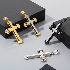 Detailed view of four double-layer stainless steel cross pendants in various metallic finishes