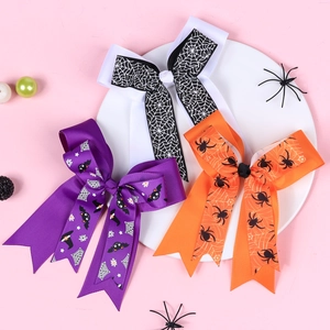 Three-piece Halloween bow hair clip set with spider and bat prints on ribbed ribbon