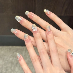 Detail of blue cat eye gradient press-on nails with 3D handmade flowers and pearls