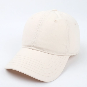 Close-up of beige cotton baseball cap detailing the six-panel stitching and fabric texture