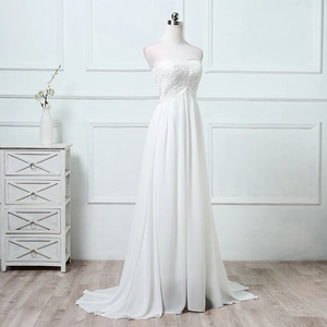 Close-up of elegant lace embroidery and layered chiffon skirt on a white wedding dress