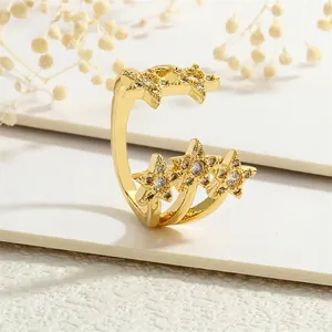 Detail of gold-plated brass ring with five stars featuring sparkling zircon inlay